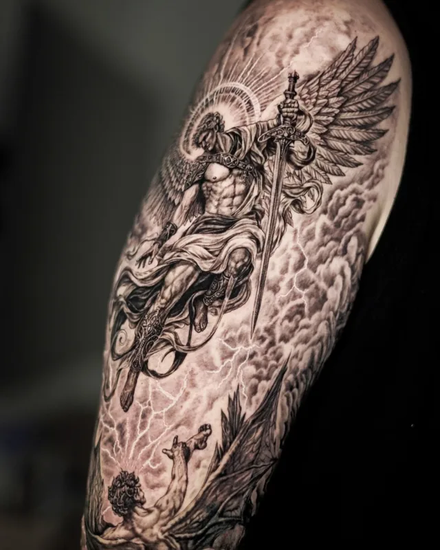 Black and grey realism sleeve of a winged archangel with clouds, tattooed at Mason's Ink Bali