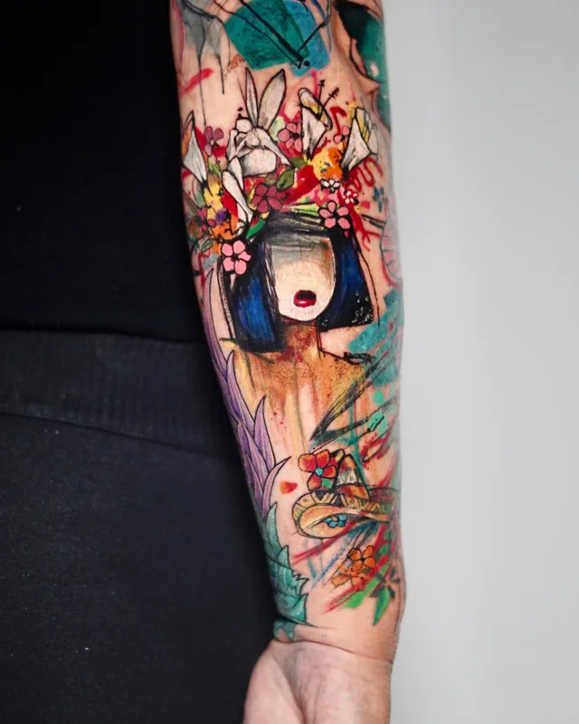 Colourful abstract forearm sleeve with flowers, a woman's face and paint splashes