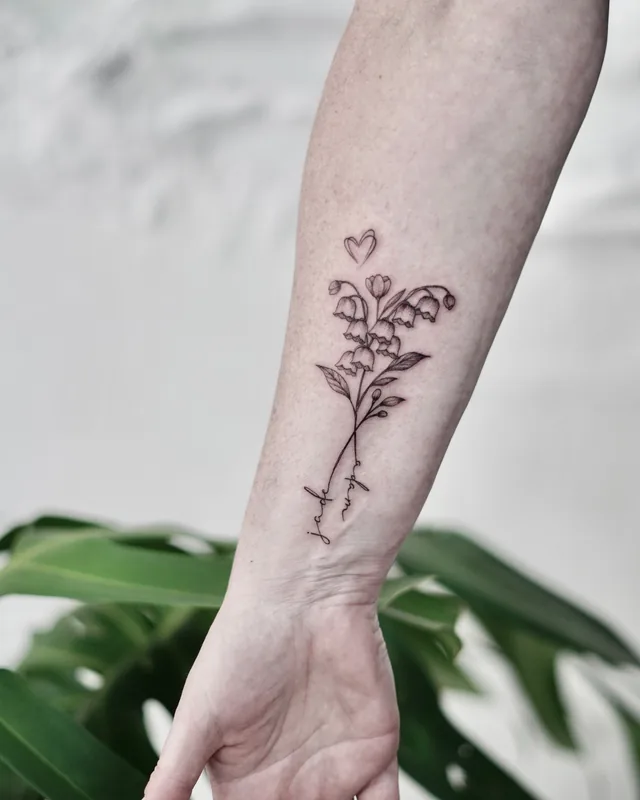 Fine line lily of the valley flowers with a small heart on the wrist