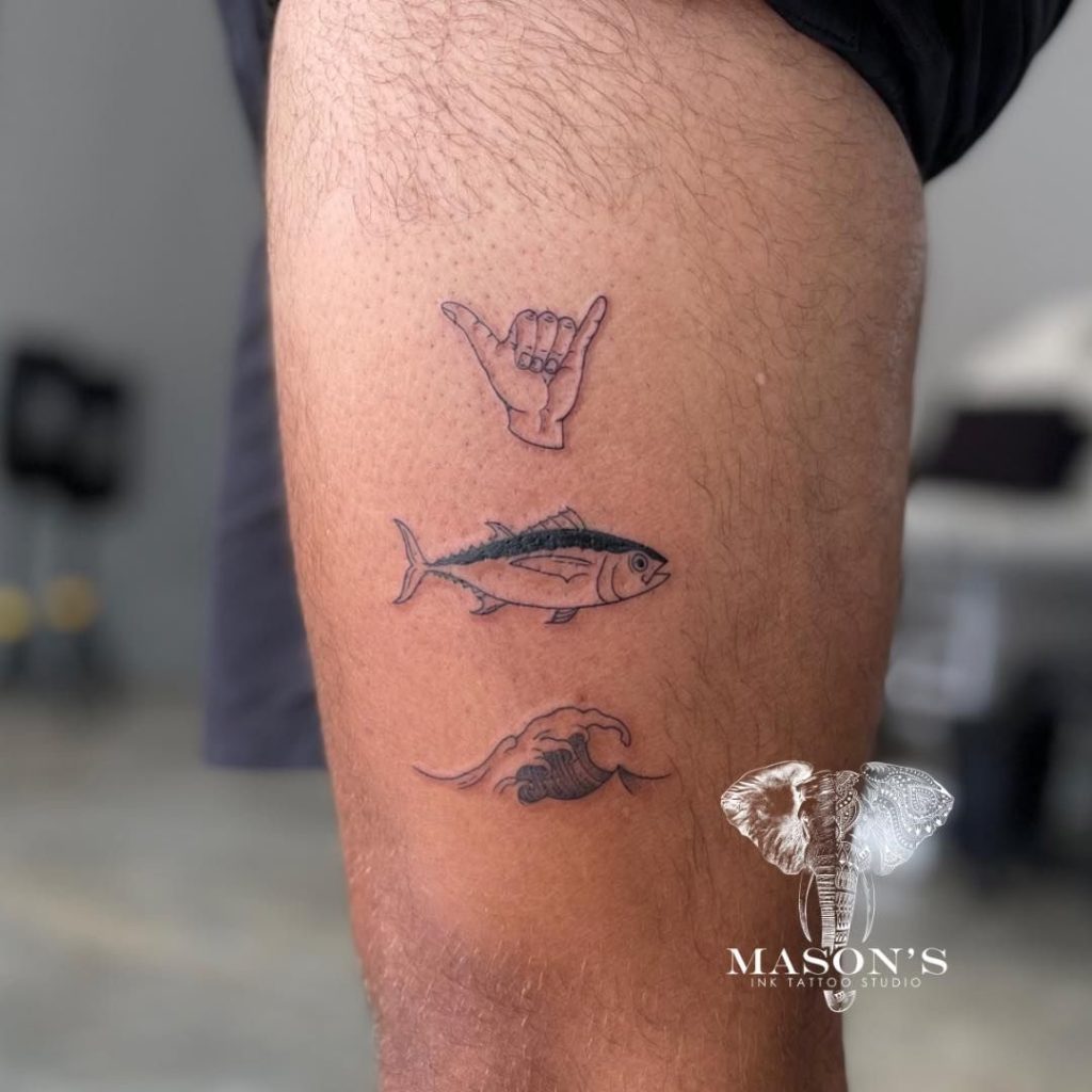 Personalized Fine Line Tattoo of a hand. fish, and wave